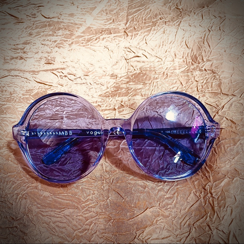 Purple vogue sunglasses! Very attractive on! Brand new never worn outside.